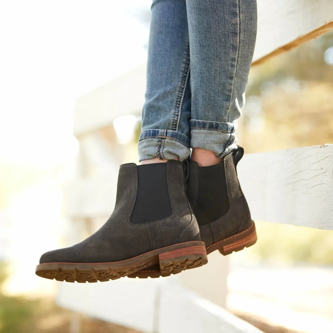 Dark brown Ariat Wexford ladies waterproof boots with rugged soles and cuffed blue jeans