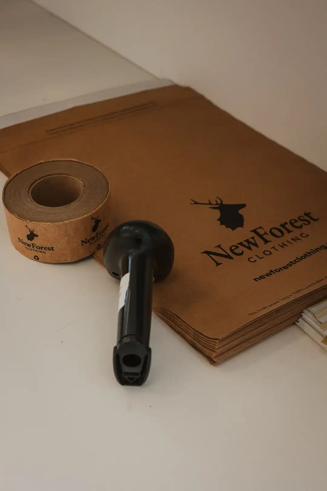 Brown paper packaging with a black deer logo.