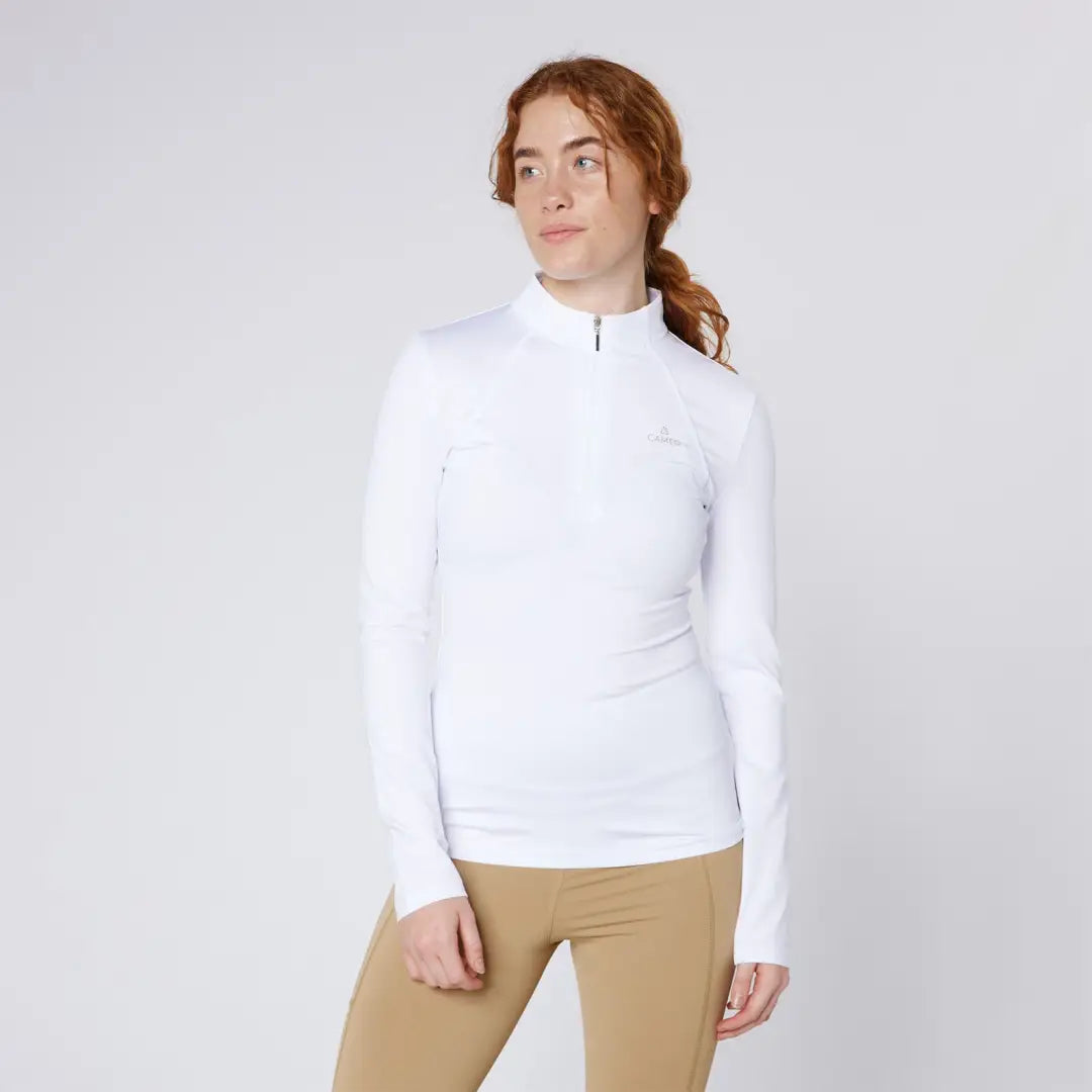 Woman in white long-sleeve shirt and tan leggings wearing Cameo Core Collection Baselayer for country clothing and hunting activities