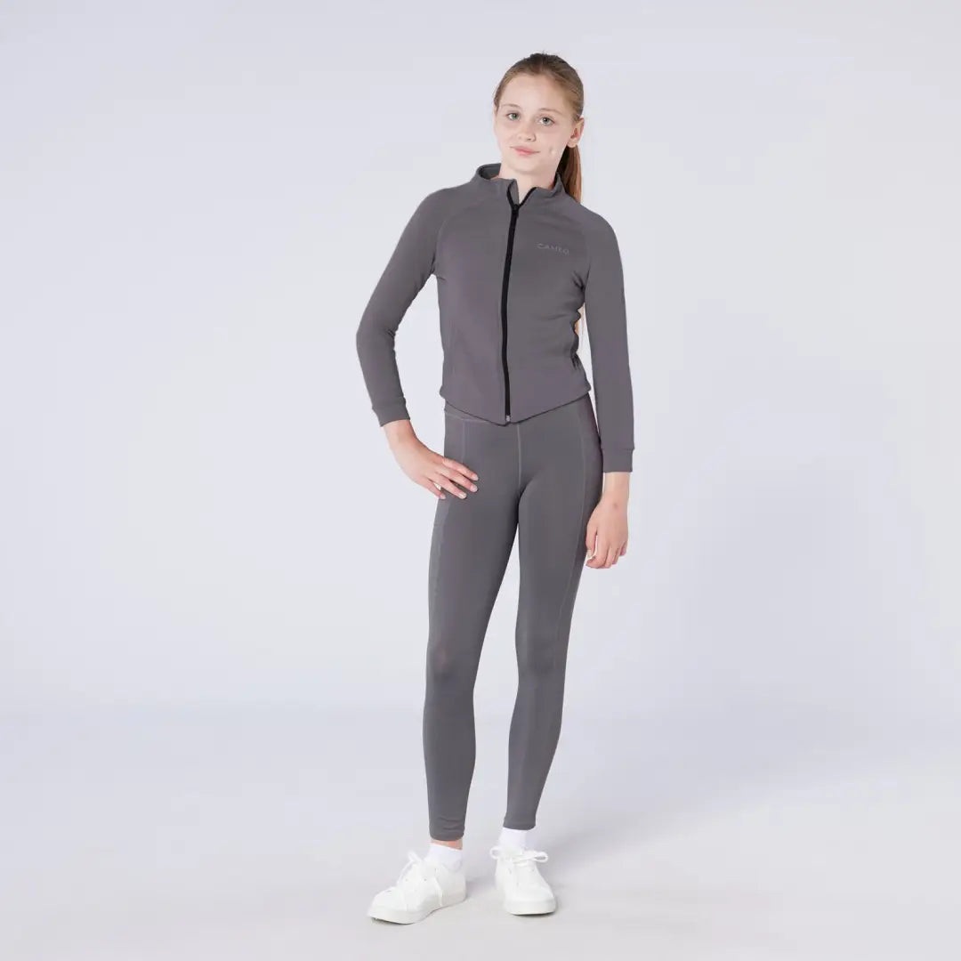 Cameo Junior charcoal gray zip-up tracksuit with ponytail and white sneakers
