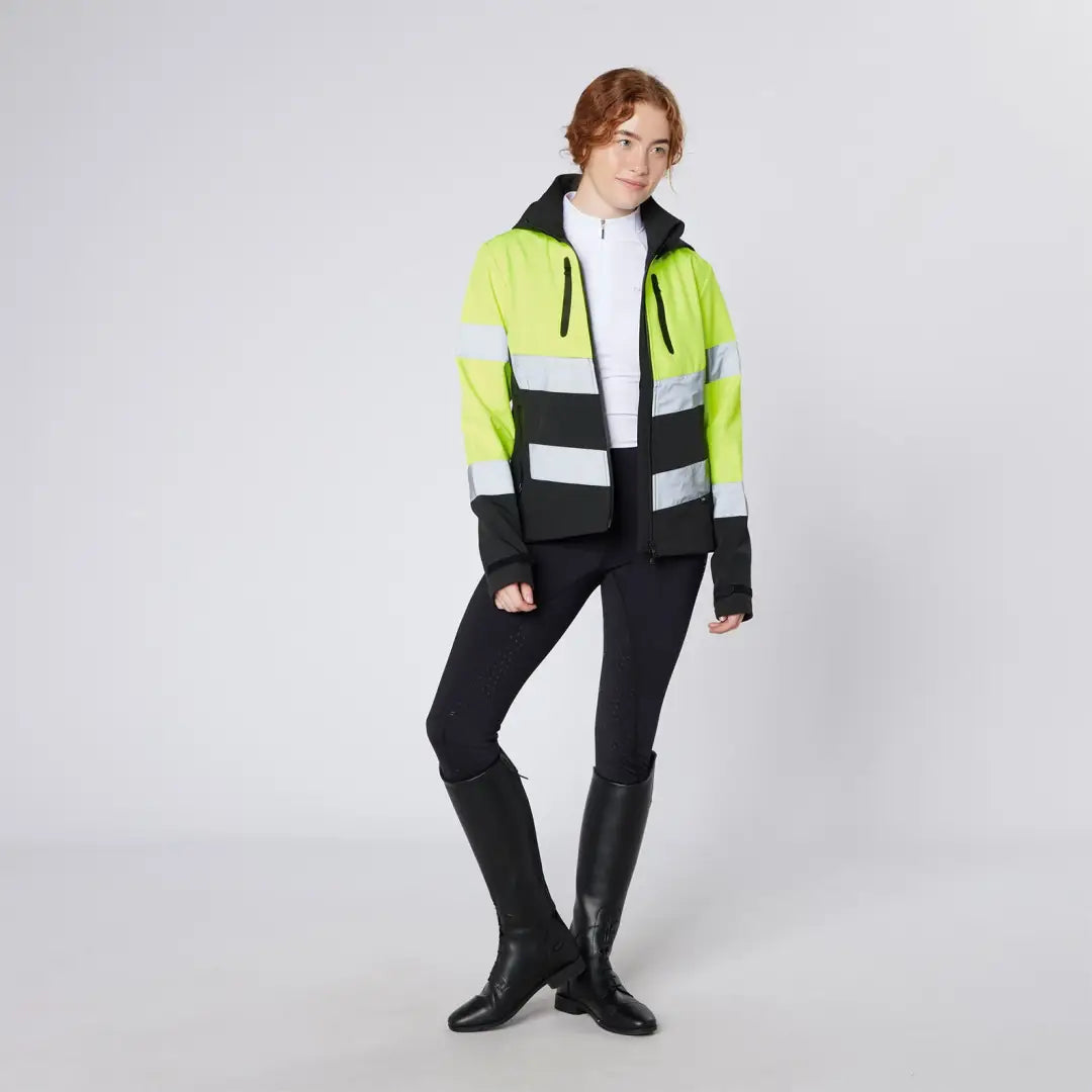 Woman in Cameo Water Repellent Hi Viz Jacket with leggings and riding boots