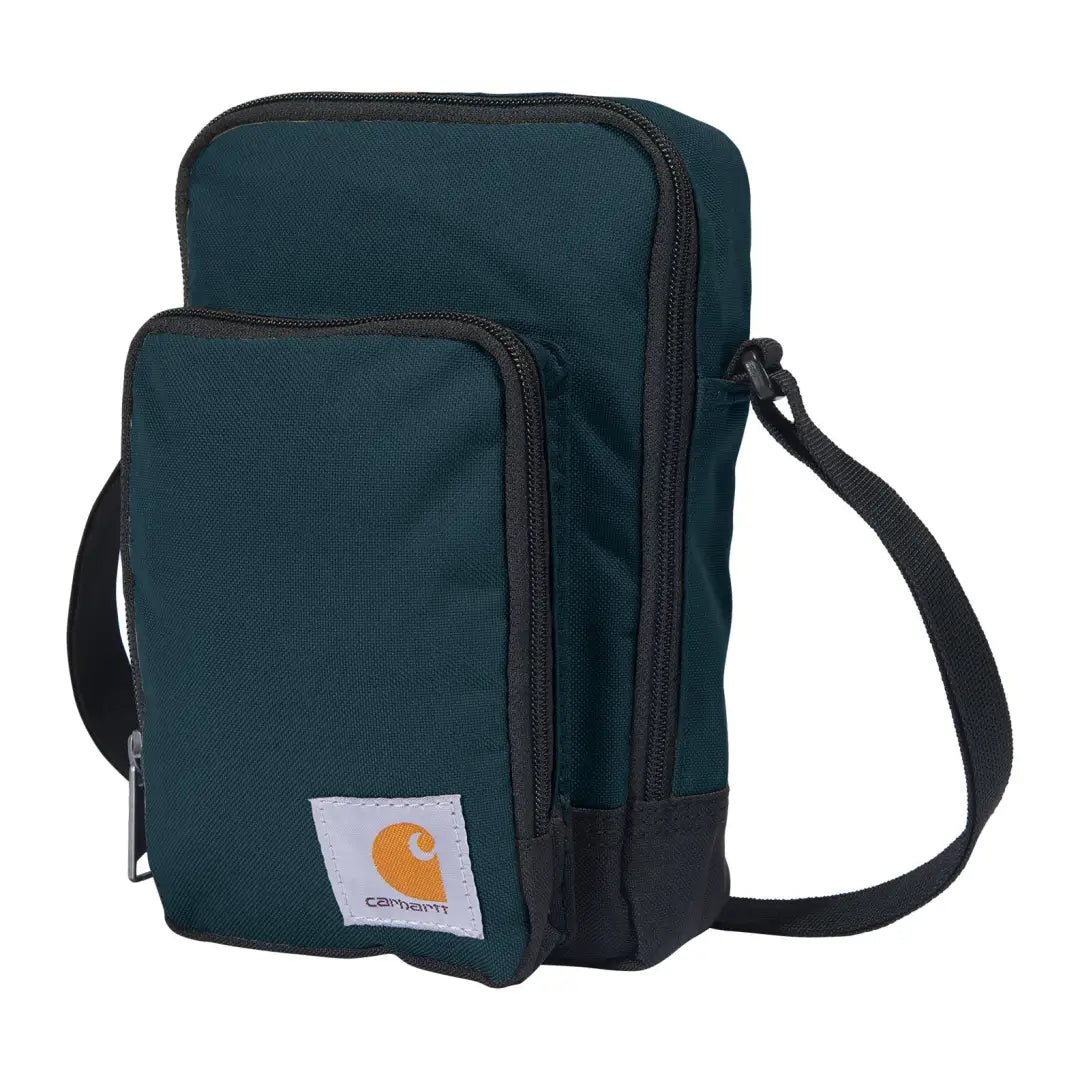 Dark teal Carhartt crossbody zip bag with black zipper trim and strap