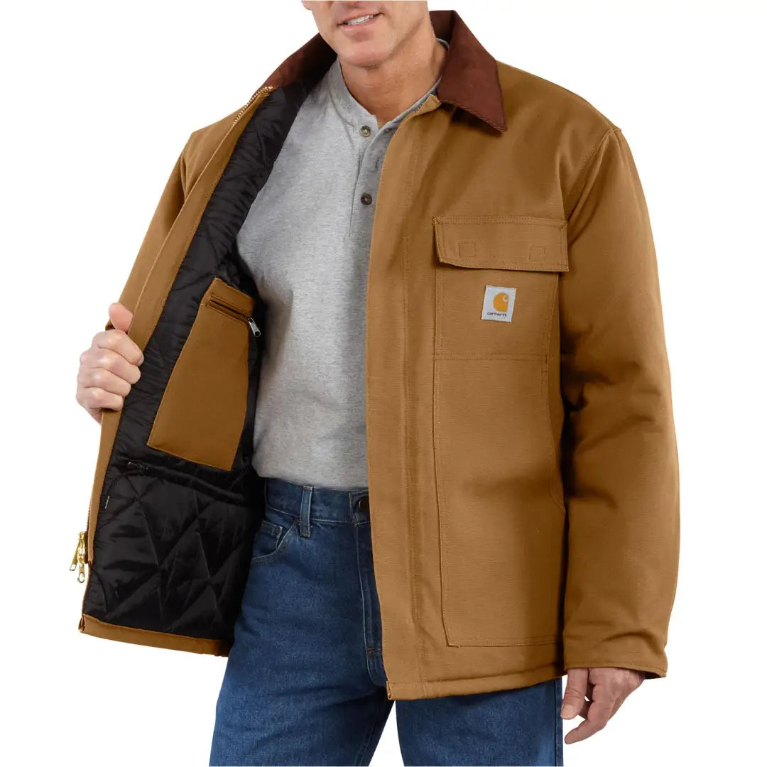 Rugged Carhartt Firm Duck Traditional Coat with brown exterior, black lining, and pockets for outdoors hunting