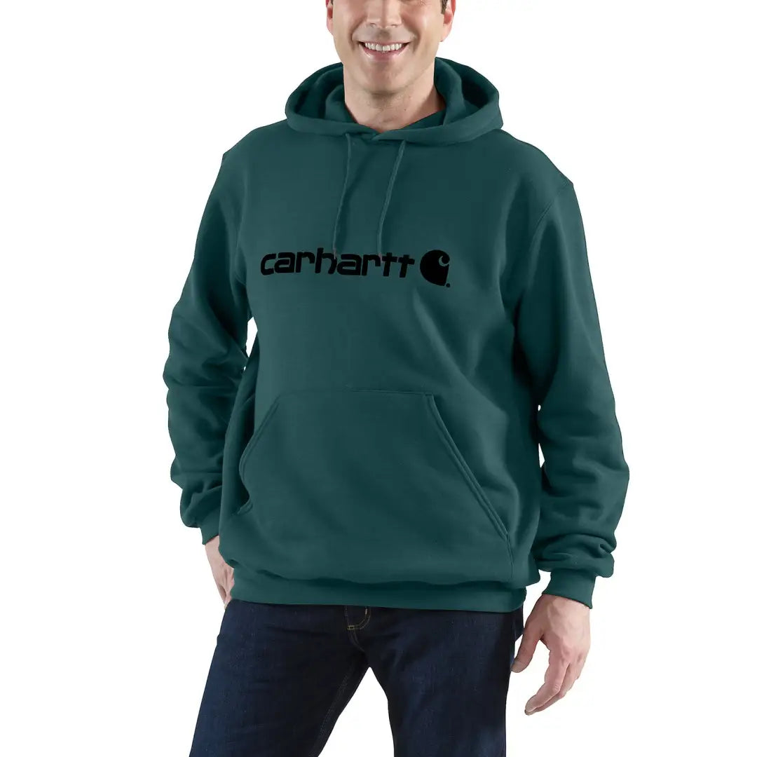 Man in a green Carhartt loose fit hoodie, perfect for country clothing and hunting