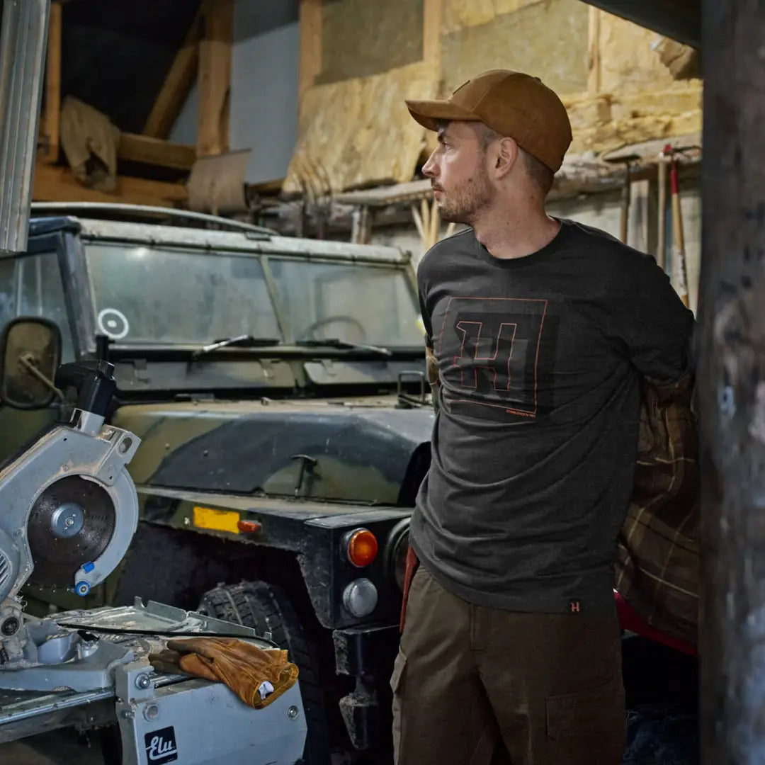 Man wearing a brown cap in Harkila H-Logo Short Sleeve T-Shirt for outdoor look