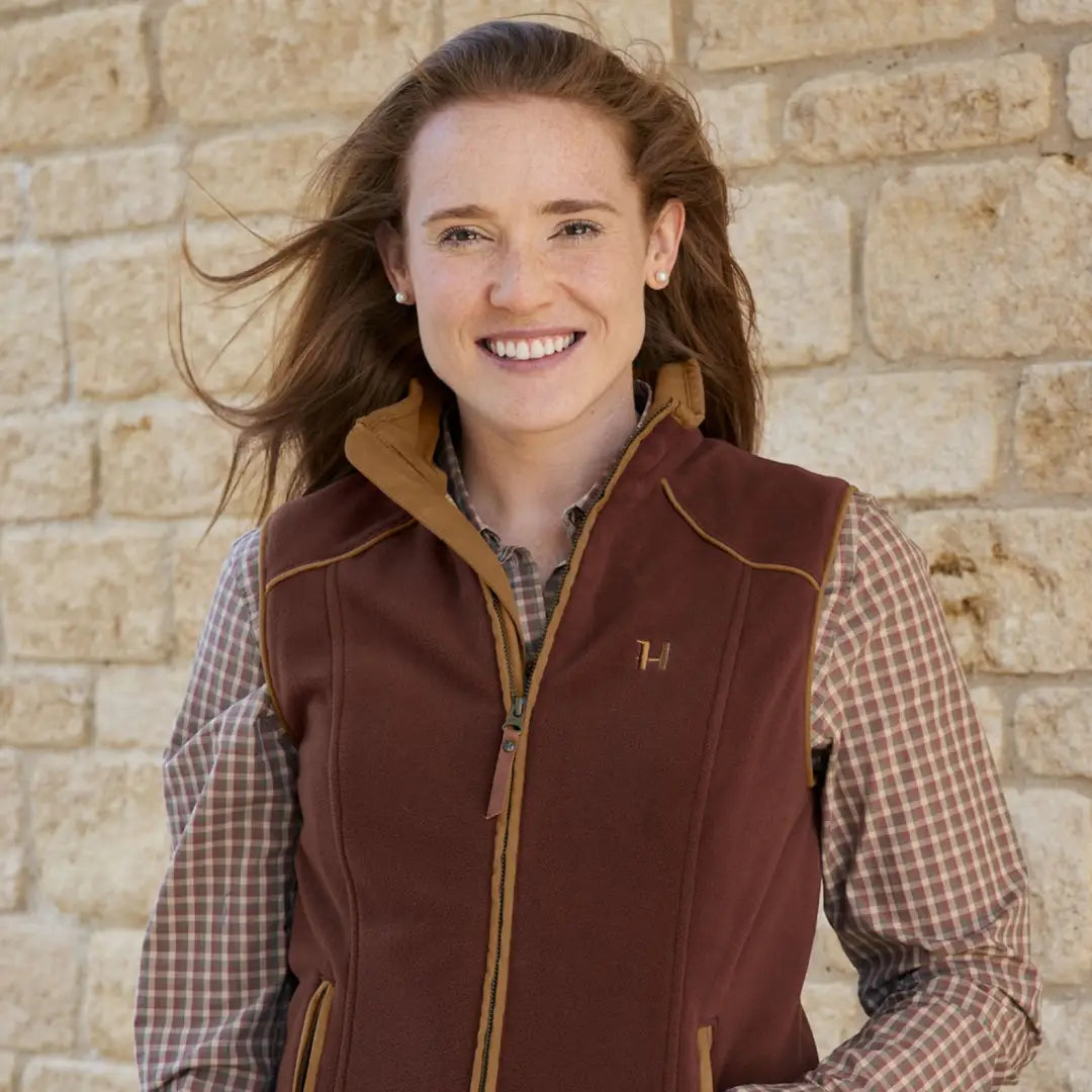 Smiling woman in Harkila Sandhem 200 Waistcoat with full-length zip and check lining