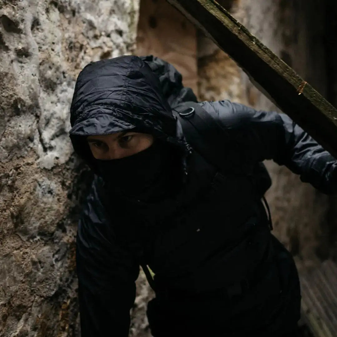 Hooded figure in dark clothing wearing the Highlander Halo Smock, perfect for wet weather