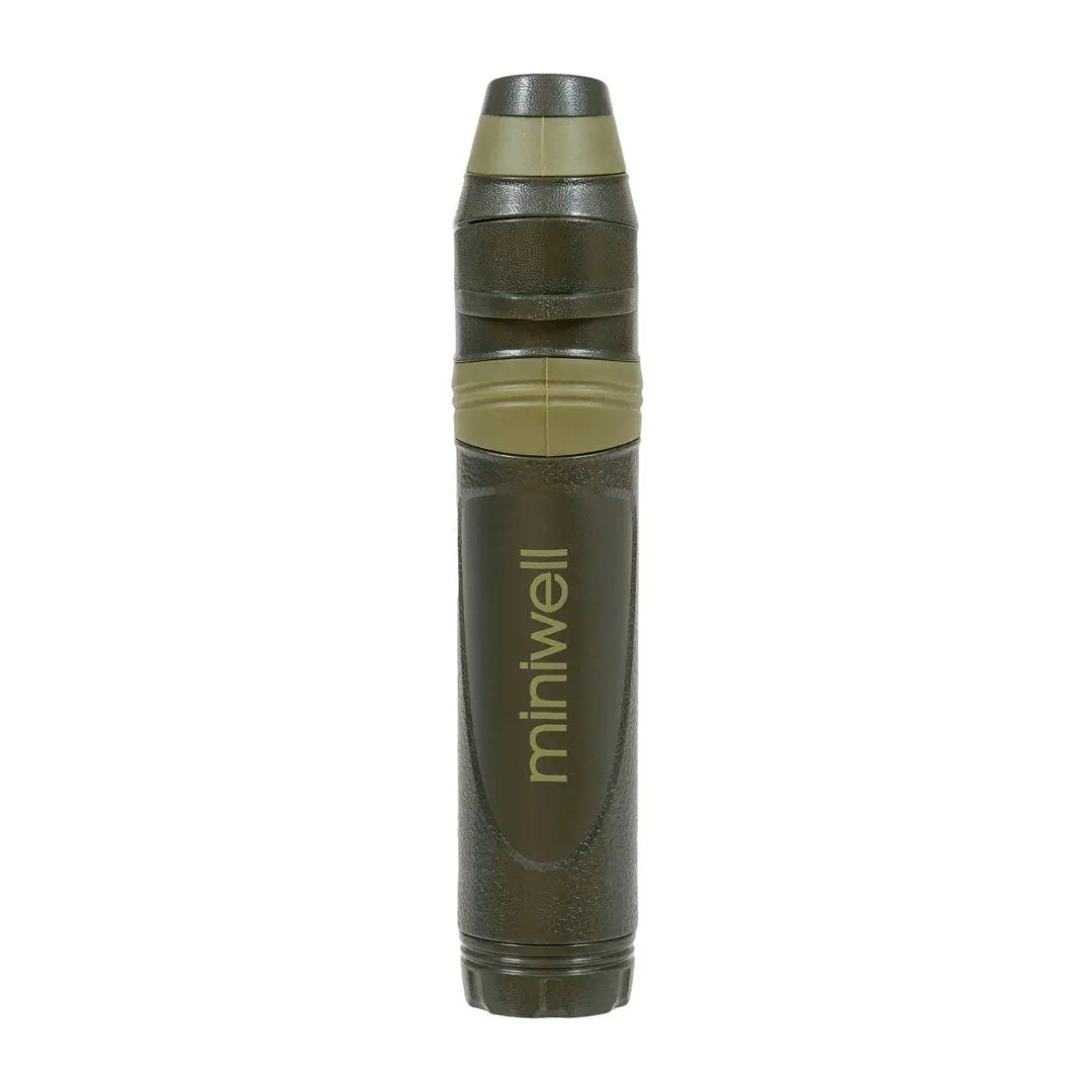 Military-style artillery shell labeled Miniwell for Highlander Straw Water Filter outdoors