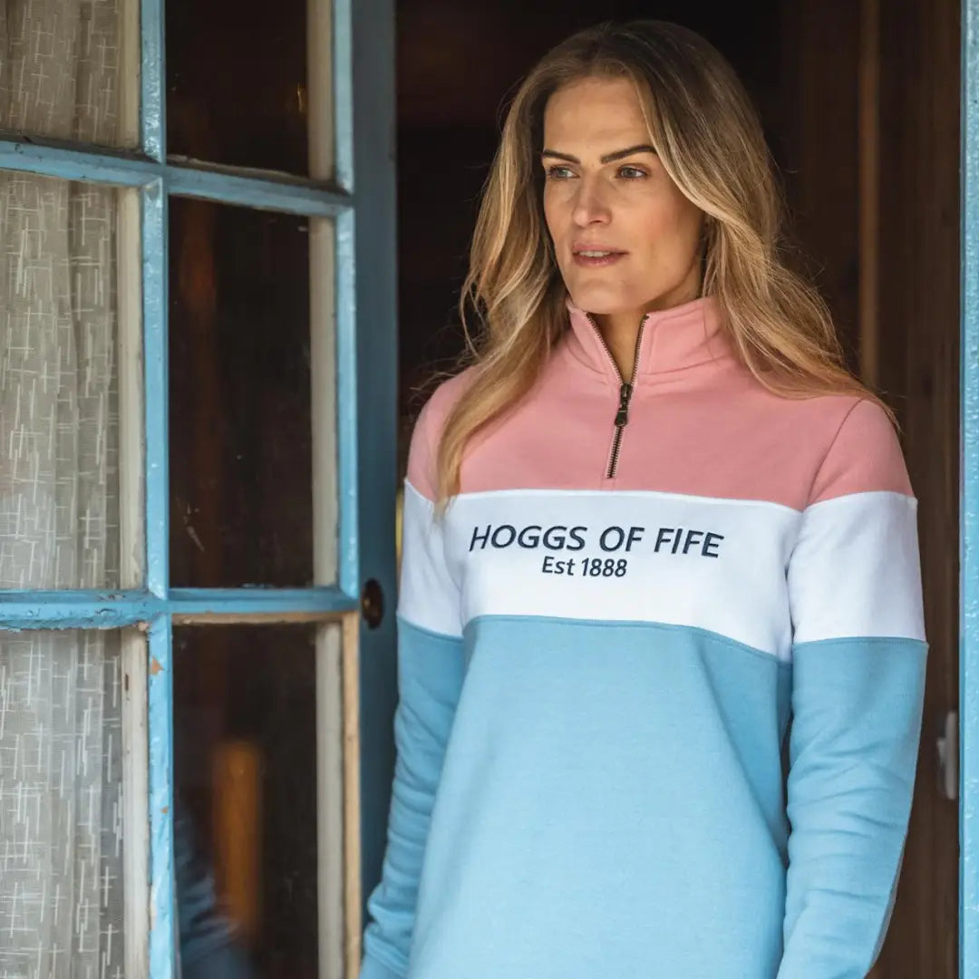 Blonde woman rocking a Colorblock Hoggs Of Fife ladies quarter zip sweatshirt