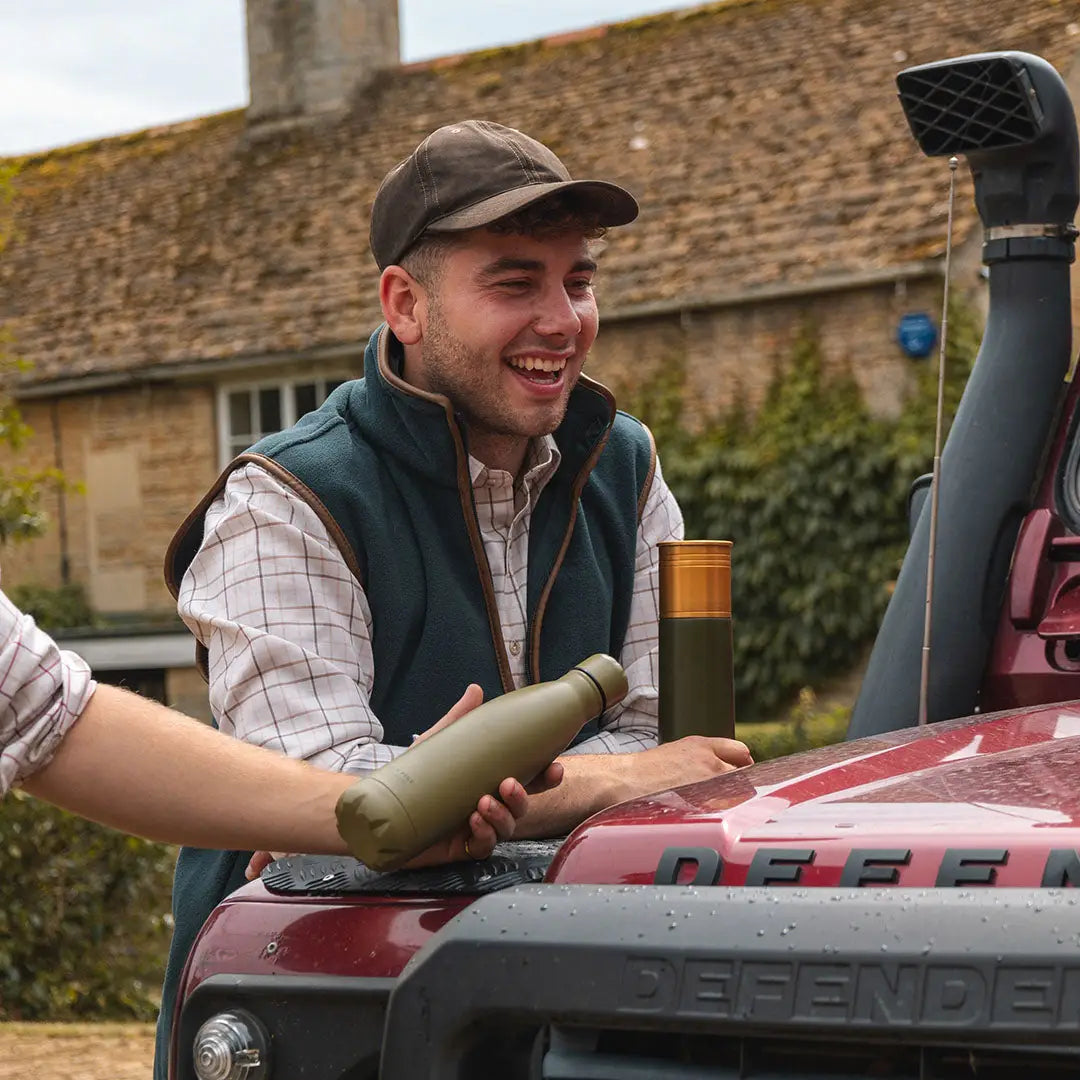 Red Land Rover Defender with Jack Pyke Countryman Fleece Gilet in 300gsm micro fleece