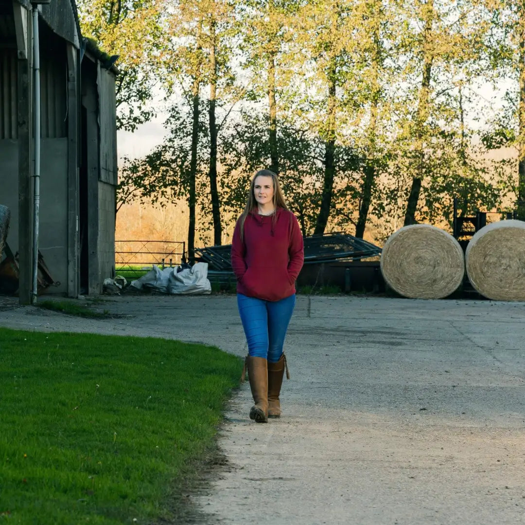 Woman in maroon hoodie from Jack Pyke Ladies Fleece Hoodie collection