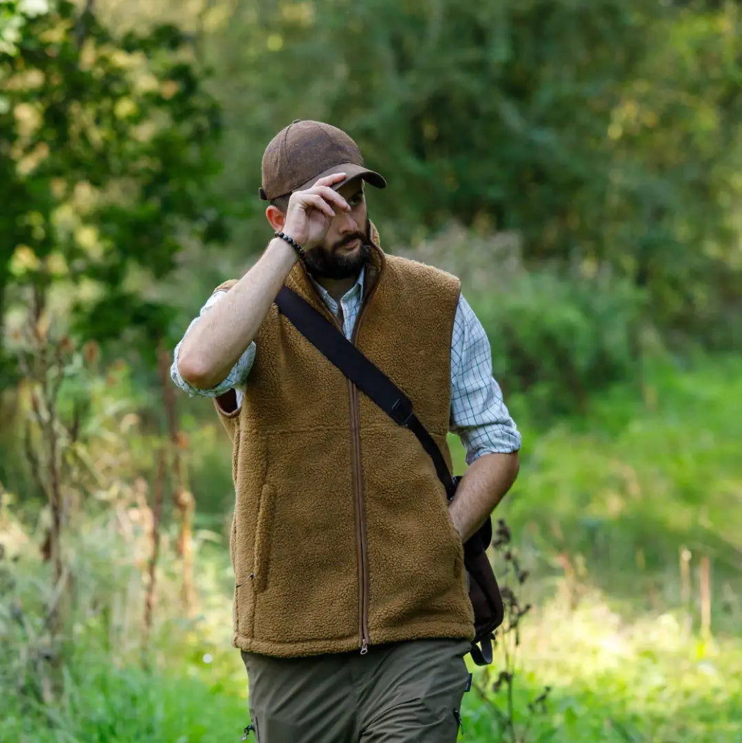 Brown fleece vest paired with Jack Pyke Lowland Tweed Baseball Hat for a cozy look