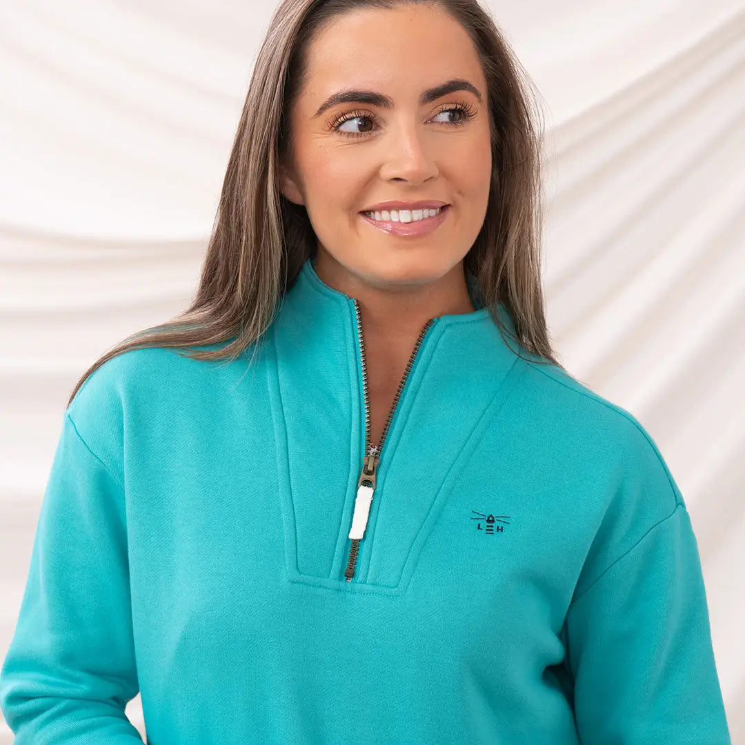Teal quarter-zip sweatshirt from Lighthouse Ladies Coral Jersey collection for ladies coral jersey lovers