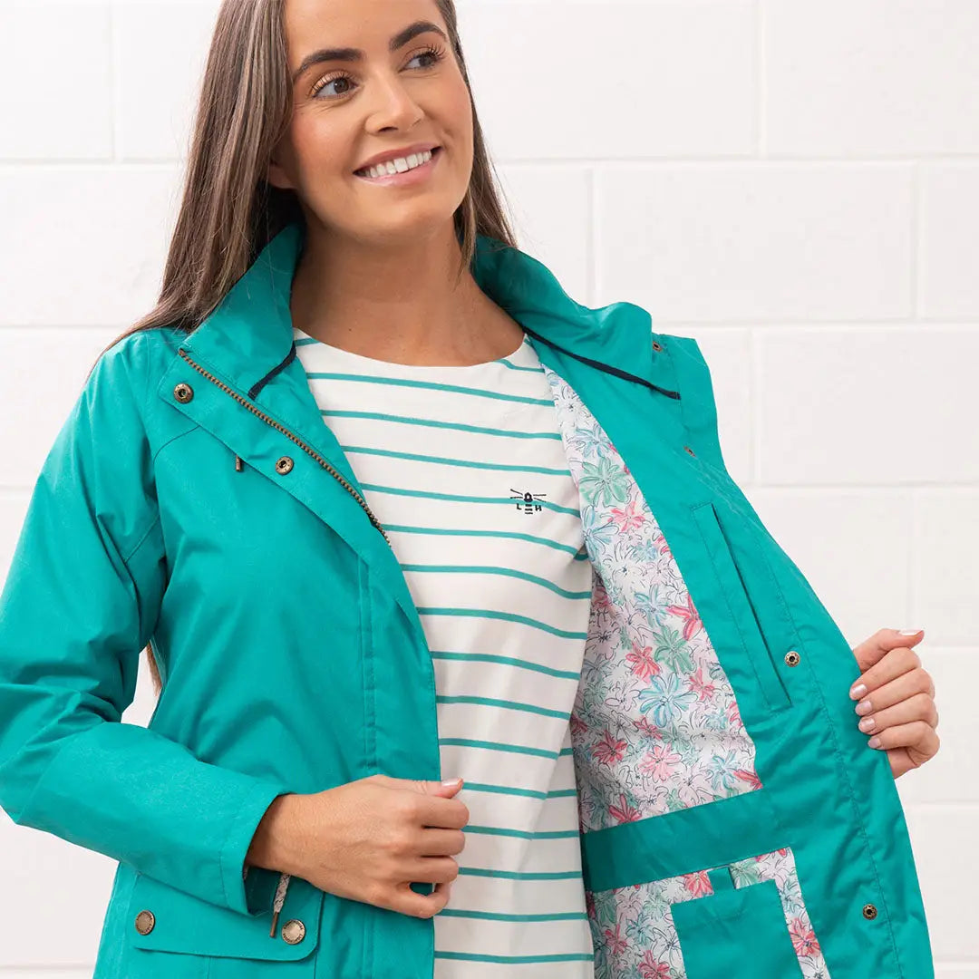 Teal Lighthouse Ladies Willow Coat featuring a chic floral lining for stylish rain protection
