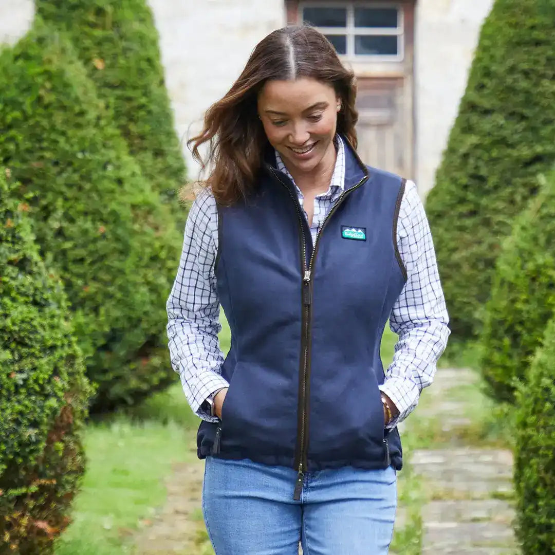 Woman in a navy vest showcasing the stylish Ridgeline Womens Monarch Gilet for country clothing