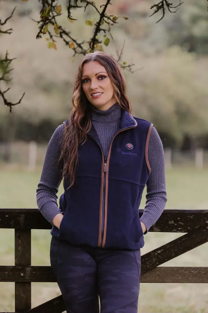 Woman wearing a navy heated fleece gilet, perfect for cozy outdoor adventures