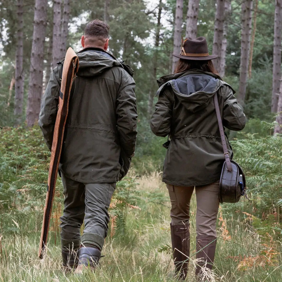 Two people in hunting outfits walking through forest in New Forest Ladies Marsh Jacket