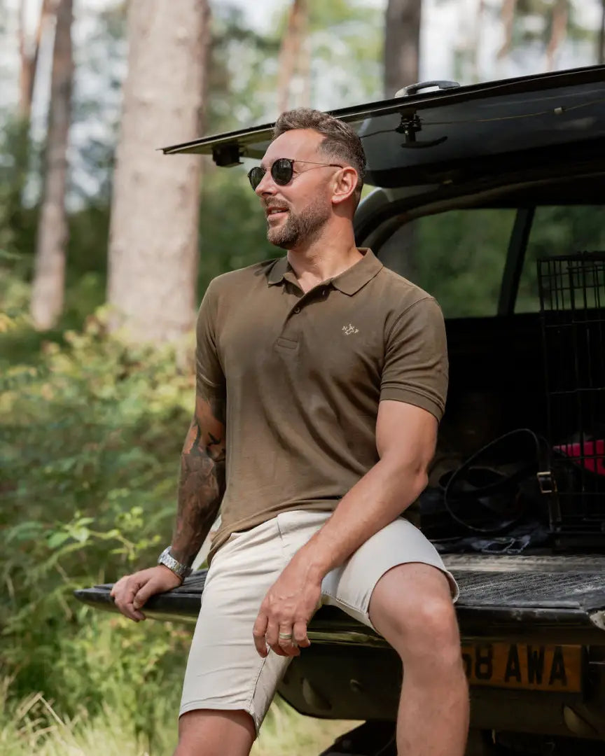 Man in olive forest pique polo shirt and khaki shorts showcasing the New Forest Pique Polo