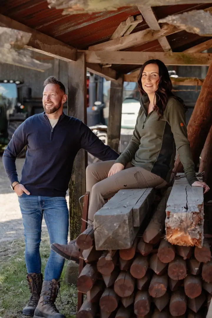 Two people wearing stylish New Forest Zip Neck Jumper outdoor clothing in nature
