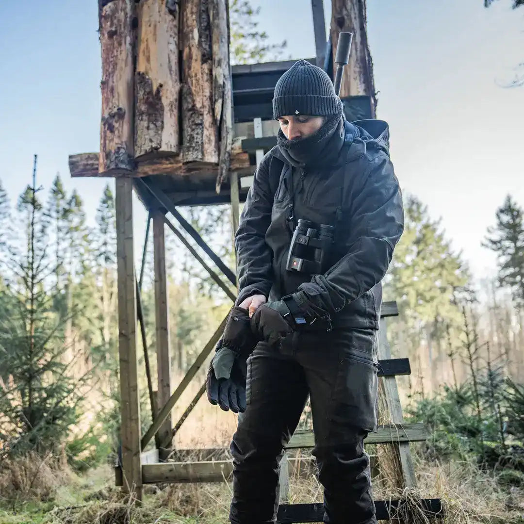Hunter in cold-weather gear wearing Seeland Celsius Heat Gloves for warmth in winter
