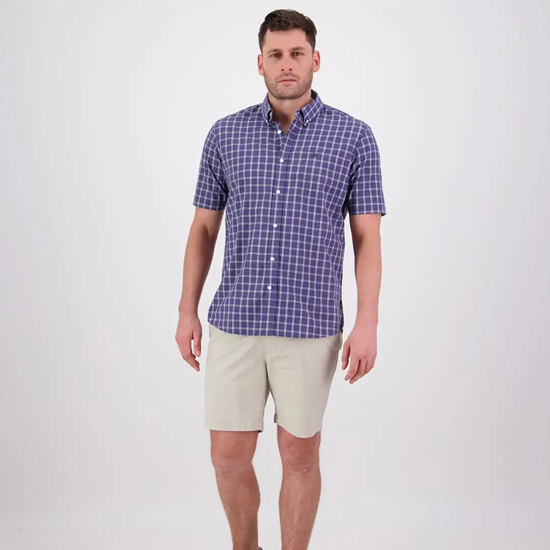 Man in a blue plaid shirt and khaki shorts wearing a Swanndri Lancewood Short Sleeve Shirt