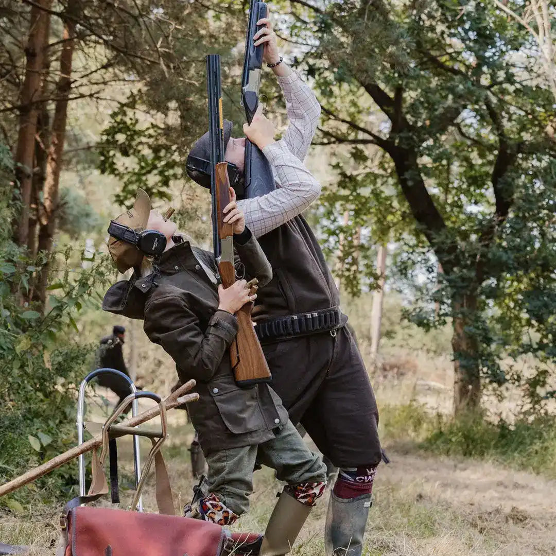 Two people in hunting attire aiming rifles, showcasing the New Forest Ladies Country Sport Jacket