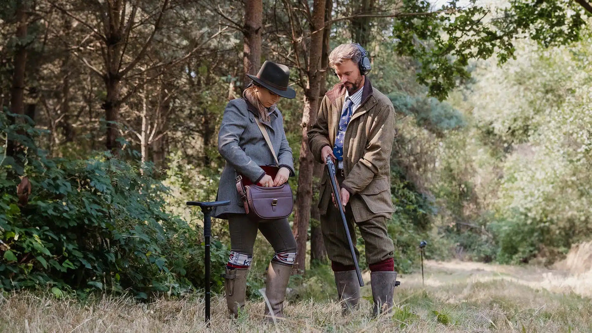 Two people hunting in the woods.
