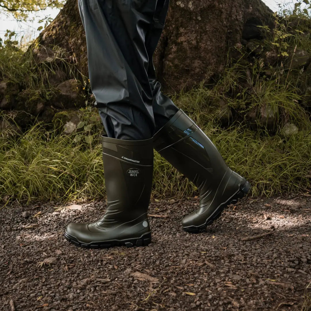 Person walking in dark green Xpert Swampmaster Titan S5 Safety PVC Wellington boots