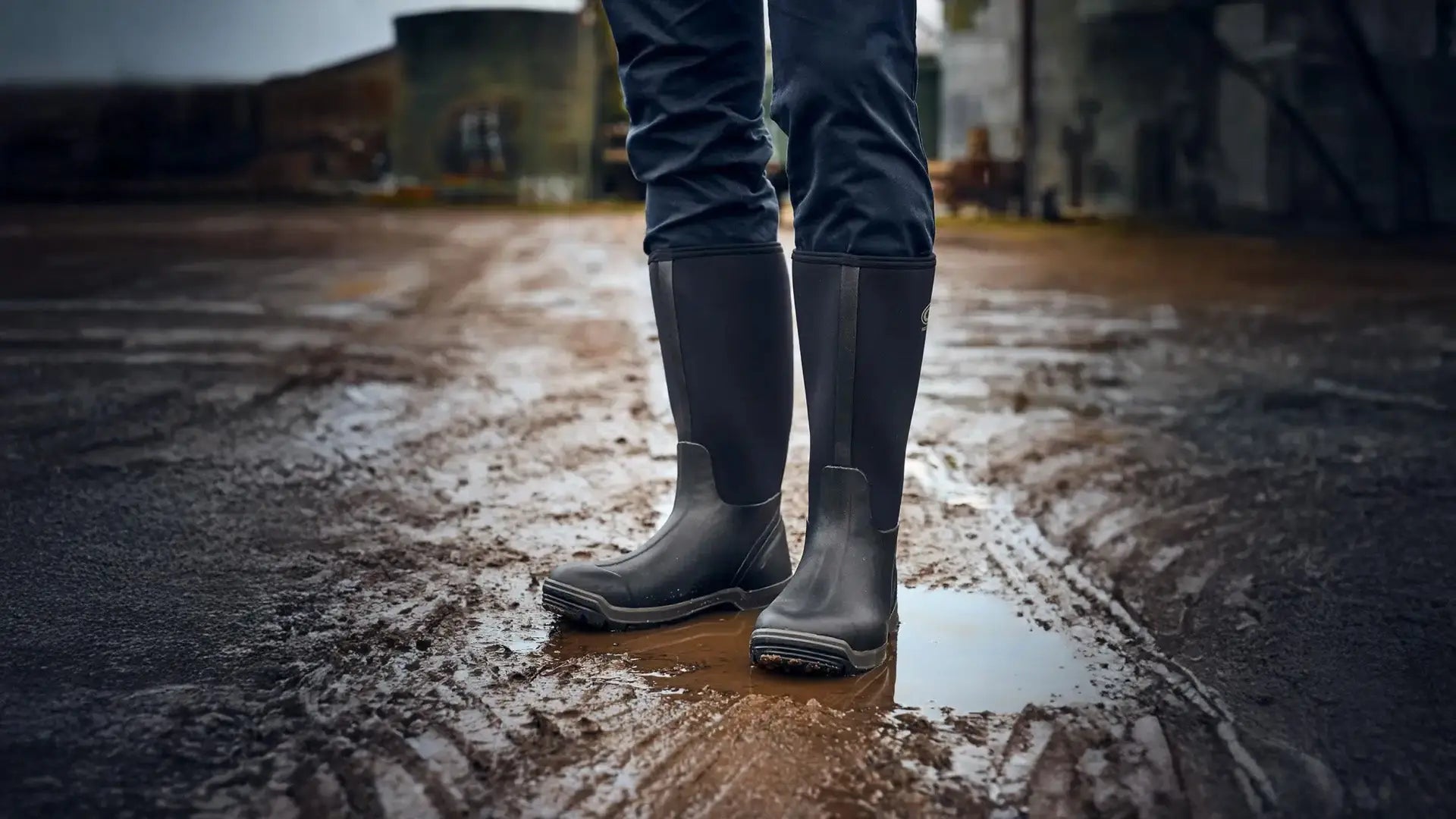Grubs boots: black wellingtons in muddy water, countryside staple