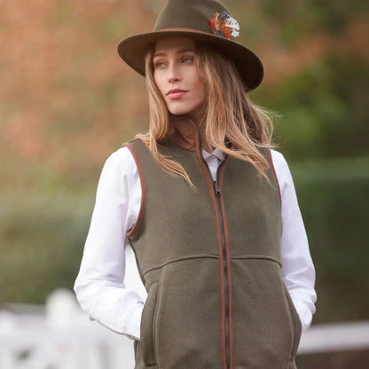 Woman wearing Alan Paine Aylsham Ladies Fleece Gilet in olive green, perfect cozy layer beneath for mild weather