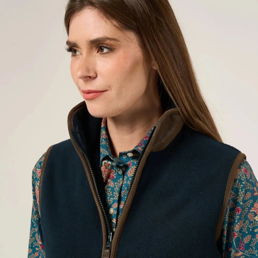 Dark blue vest with brown trim over teal floral shirt, perfect for warmer days worn