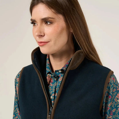 Dark blue vest with brown trim over teal floral shirt, perfect for warmer days worn