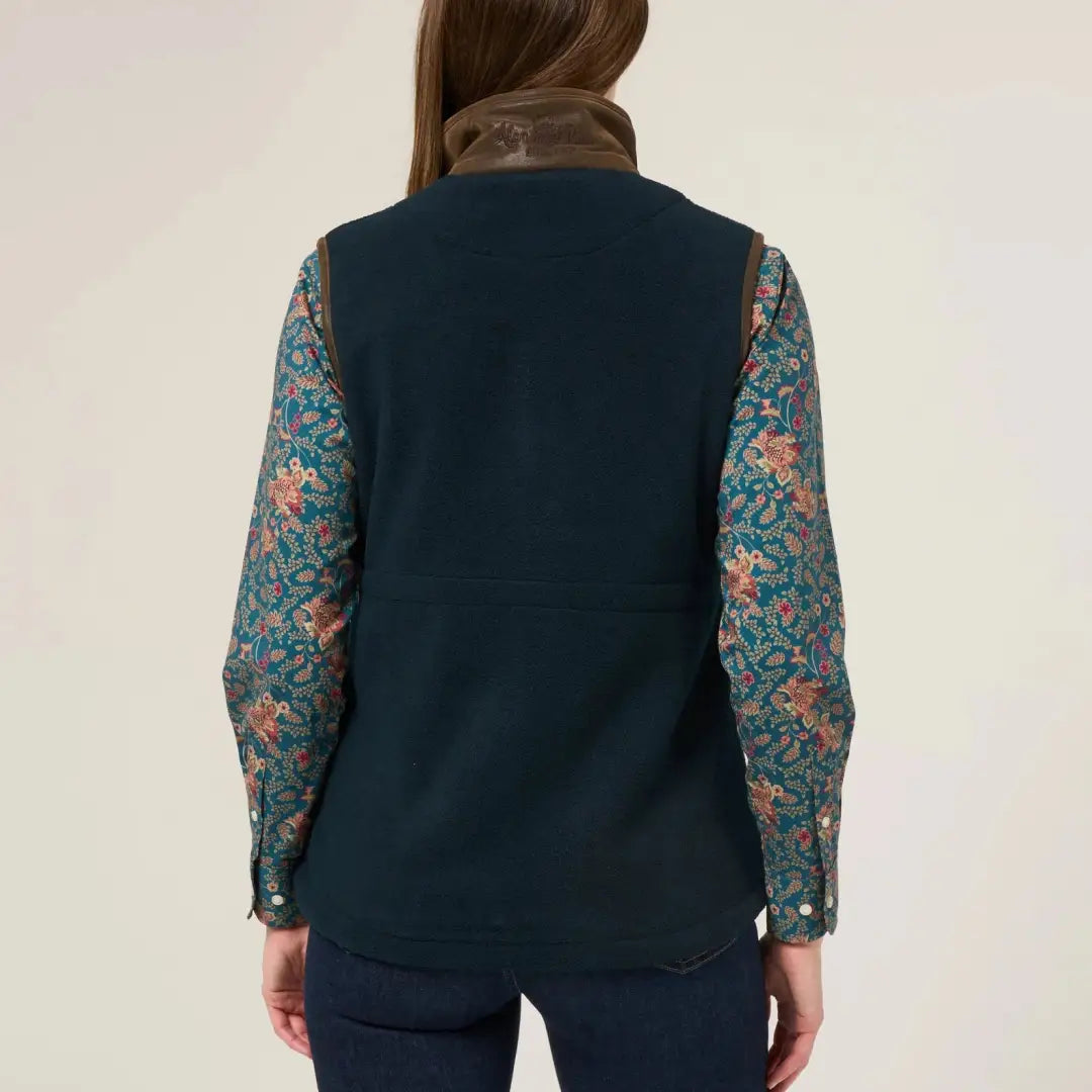 Woman’s dark teal fleece vest with brown collar, perfect for warmer days worn as extra layer underneath