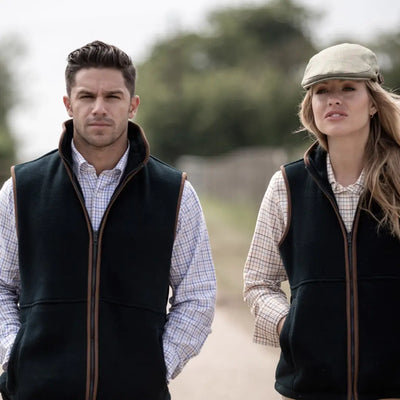 Two people in matching dark Alan Paine Aylsham Fleece Gilets and light shirts