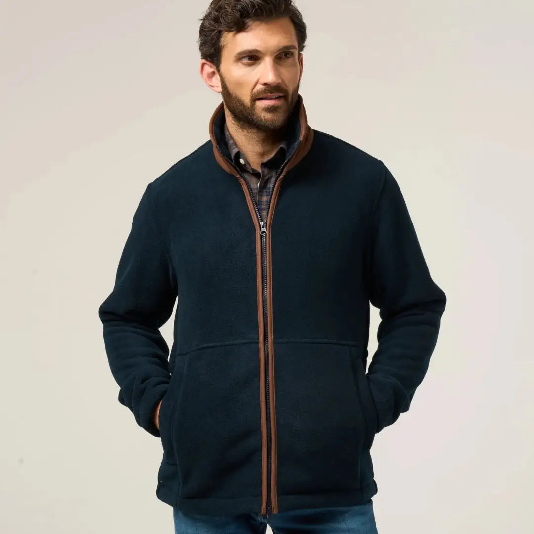 Dark blue Alan Paine Aylsham fleece jacket with brown trim and plaid shirt underneath