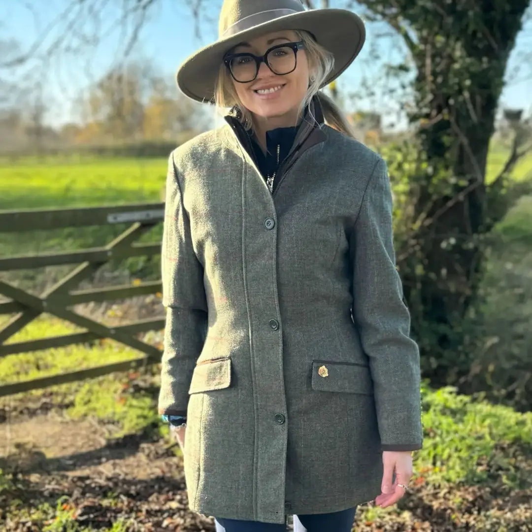 Woman in Alan Paine Combrook waterproof field jacket with tweed coat and wide-brimmed hat