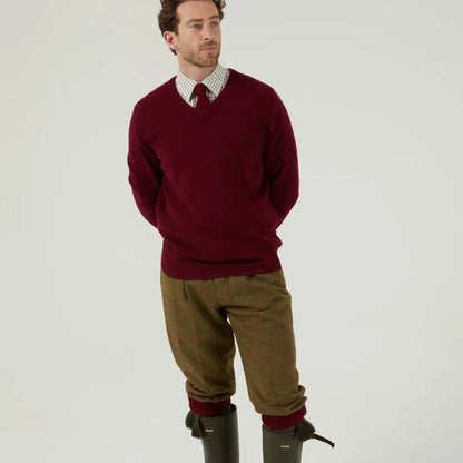 Men’s maroon V-neck sweater with tweed breeks, pure wool Combrook, and green boots