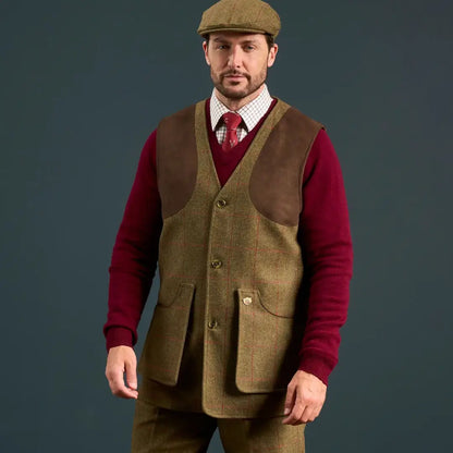 Man wearing Alan Paine Combrook water repellent pure wool tweed shooting vest with red V-neck