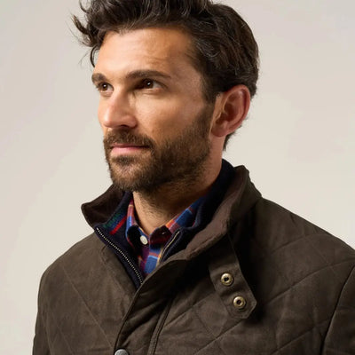 Man with beard wearing Alan Paine Felwell men’s quilted jacket over plaid shirt