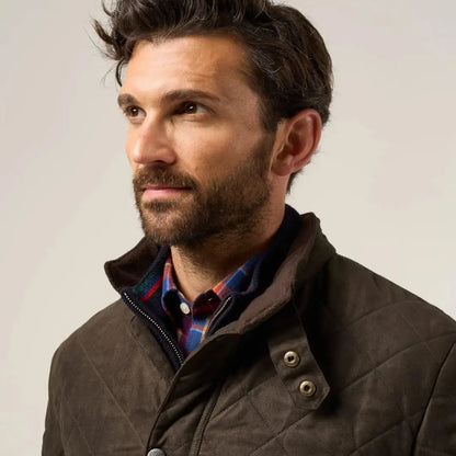 Man with beard wearing Alan Paine Felwell men’s quilted jacket over plaid shirt