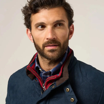 Man wearing Alan Paine Felwell quilted jacket with navy blue, red collar, and plaid shirt