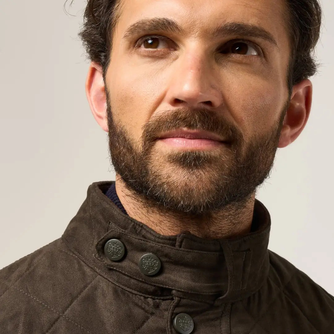 Man with beard wearing Alan Paine Men’s Felwell Quilted Jacket with buttoned collar