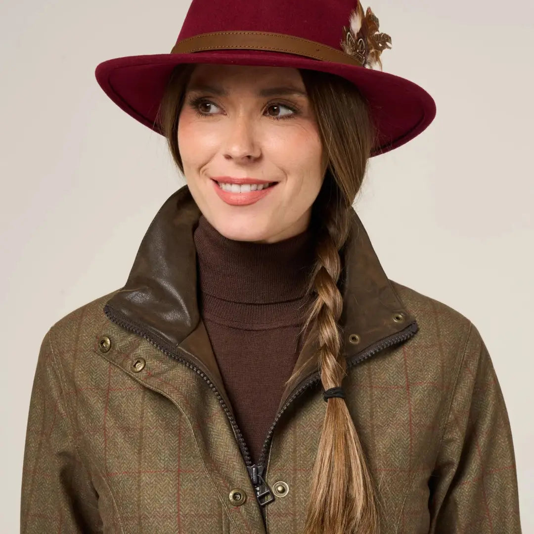 Stylish woman in brown tweed Didsmere Ladies Coat with red fedora, stay warm in luxury