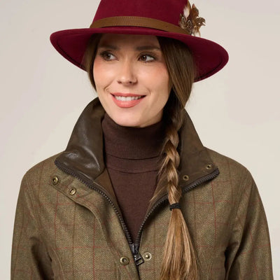 Stylish woman in brown tweed Didsmere Ladies Coat with red fedora, stay warm in luxury