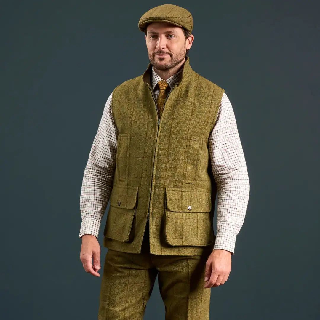 Men’s olive green tweed waistcoat from Alan Paine’s Rutland collection with matching cap