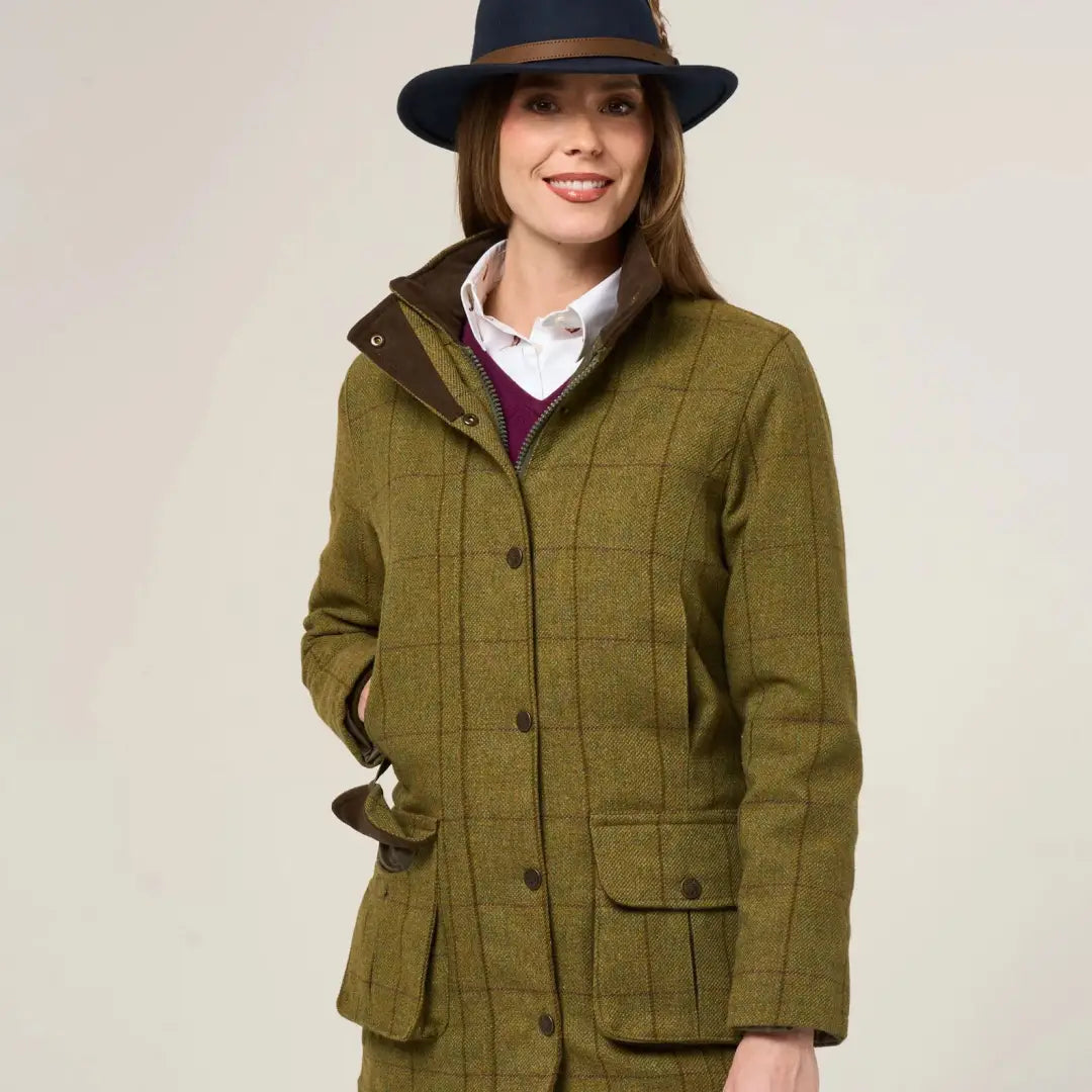 Women’s green tweed jacket with navy hat from Alan Paine Rutland durable wool blend breathable coat offers style and comfort
