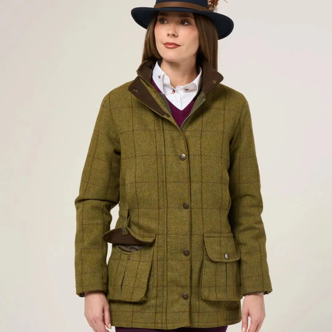 Woman in Alan Paine Rutland olive green tweed waterproof coat with durable wool blend
