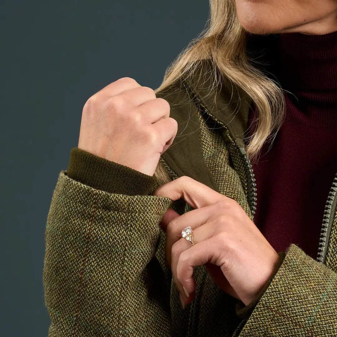 Woman in green tweed Alan Paine Rutland coat with ring, stylish waterproof look