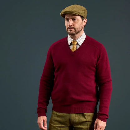 Men’s maroon V-neck sweater with checkered shirt and patterned yellow tie, perfect for Alan Paine Rutland flat cap style