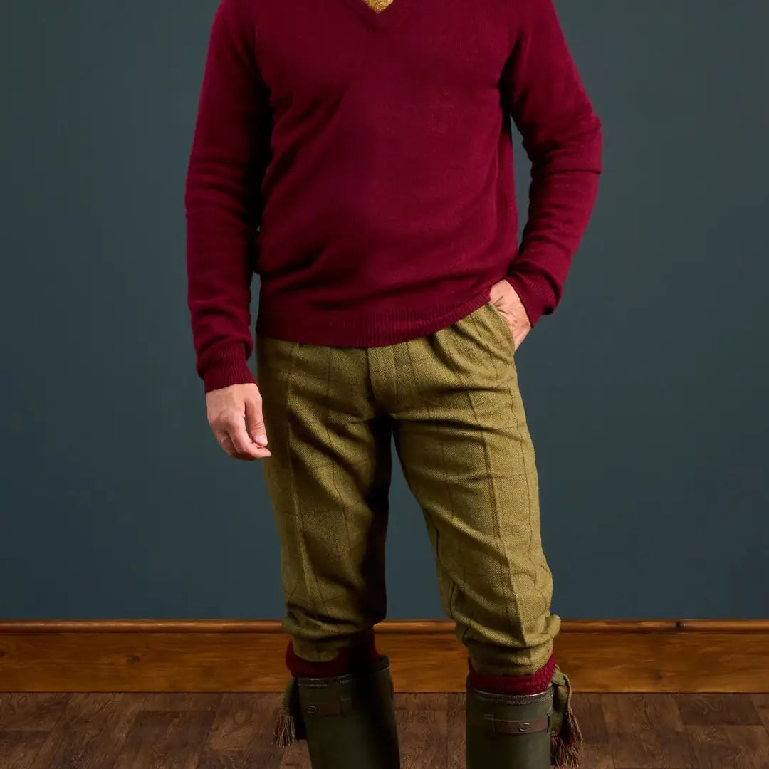 Man in red V-neck sweater and green Rutland Tweed Breeks with wellington boots